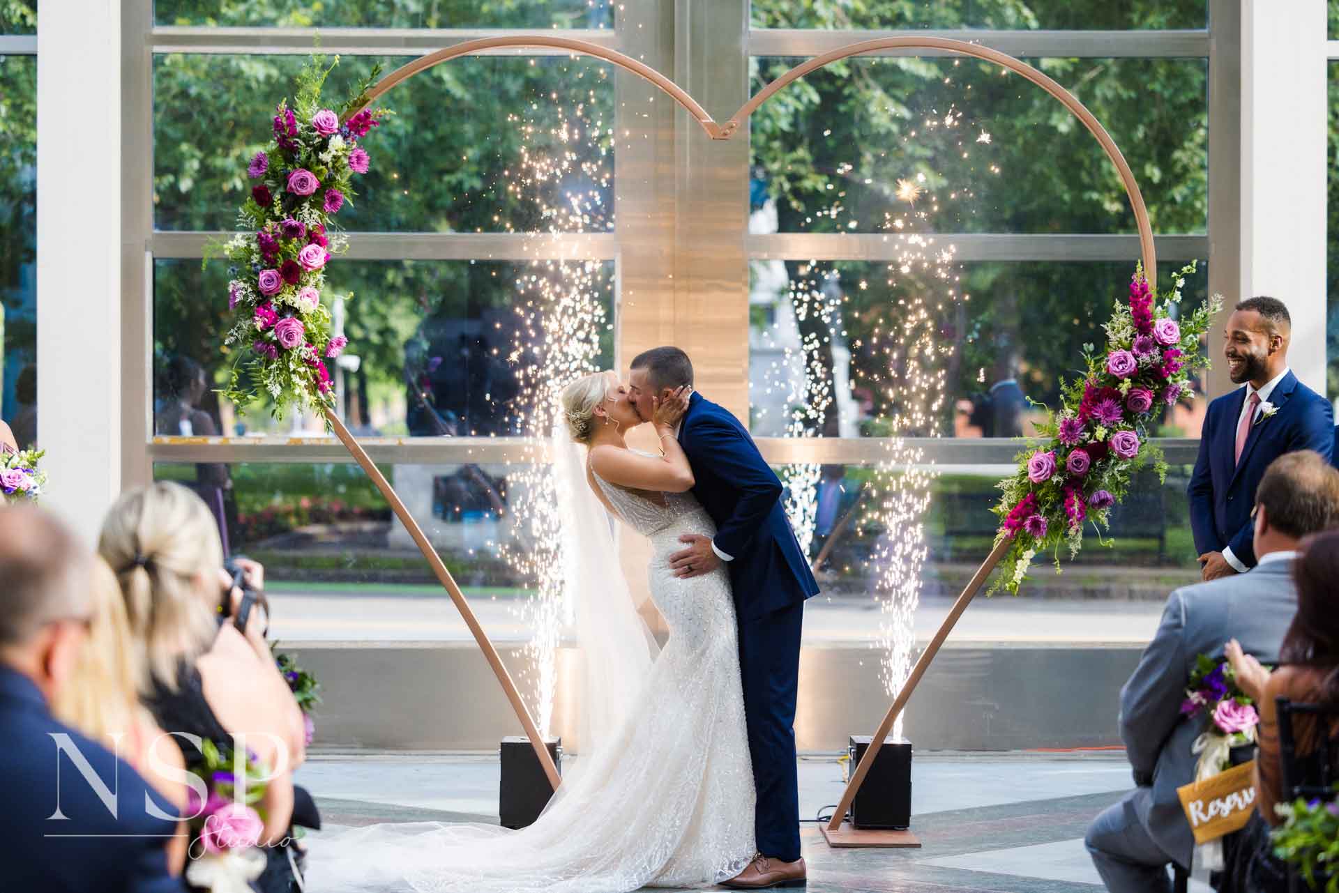 Couple kissing at altar with cold spark fountains